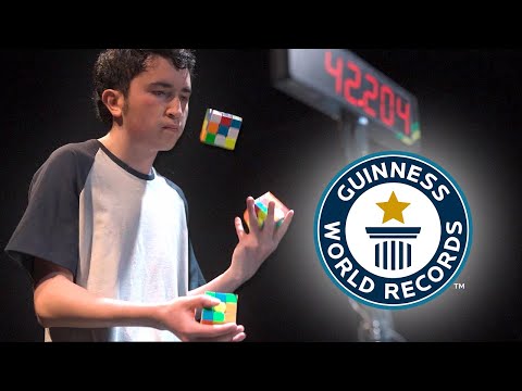 Solving Three Puzzle Cubes WHILST JUGGLING - Guinness World Records
